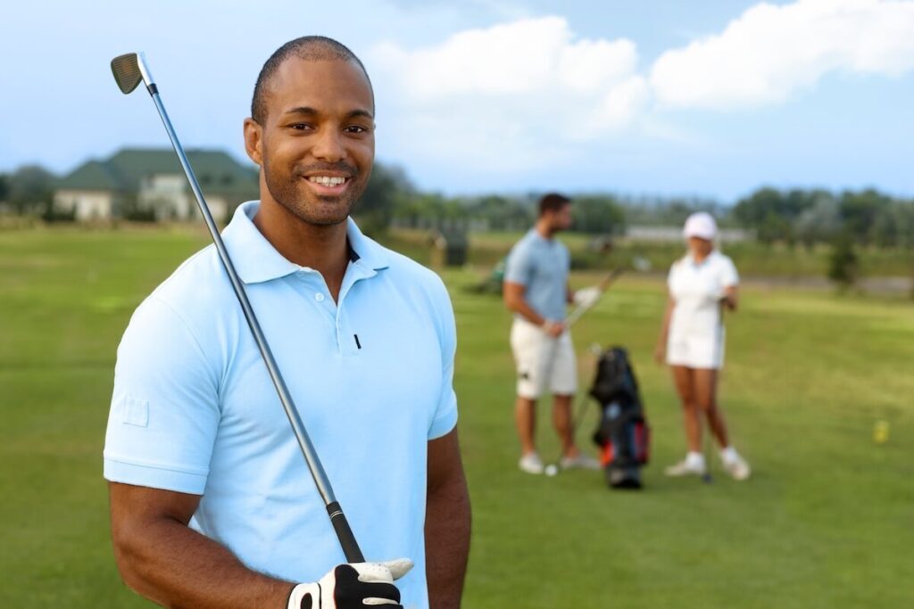 Golf swing sequence: A smiling golfer stands on a golf course with his club on his shoulder