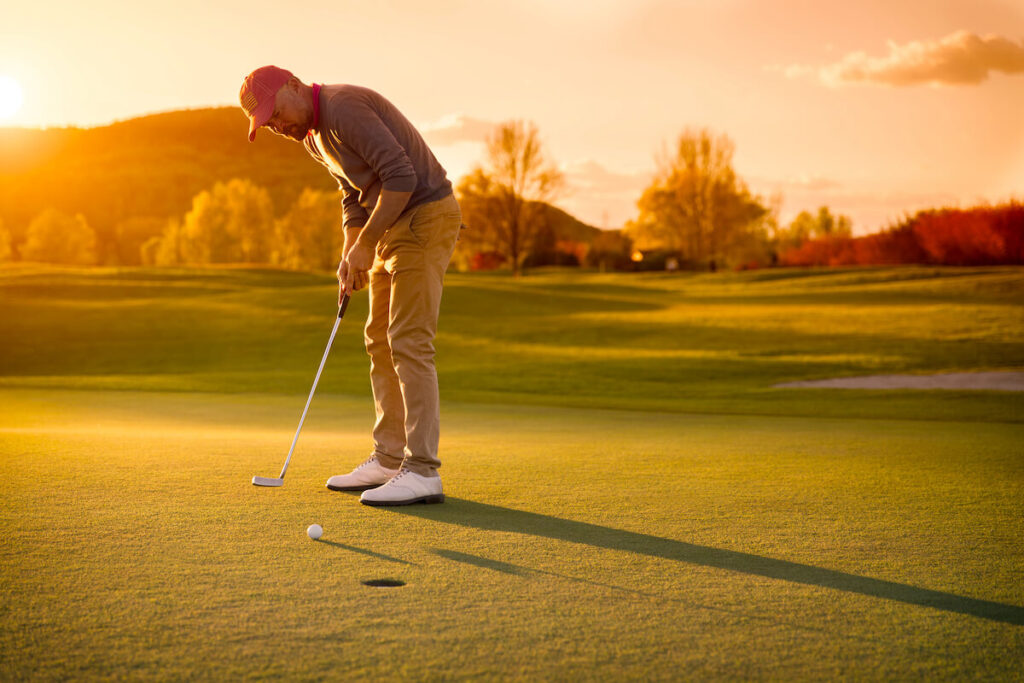 Man practicing his golf putting stroke