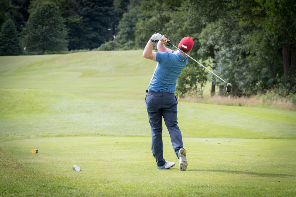 How to hit a draw: person that just took his swing at the golf ball