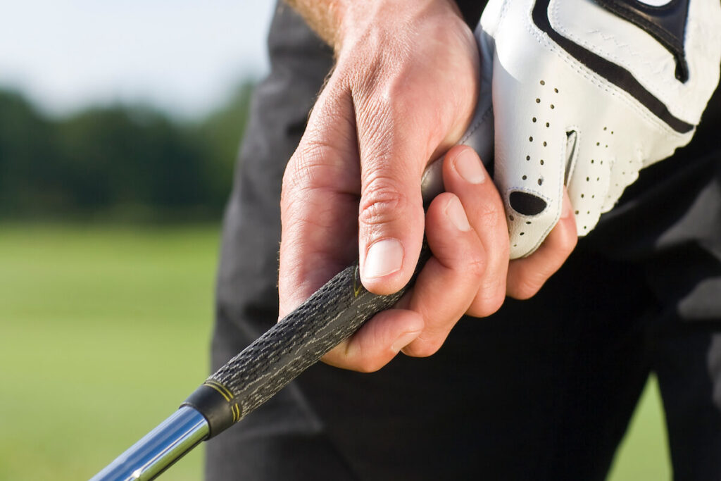 Person holding a golf club