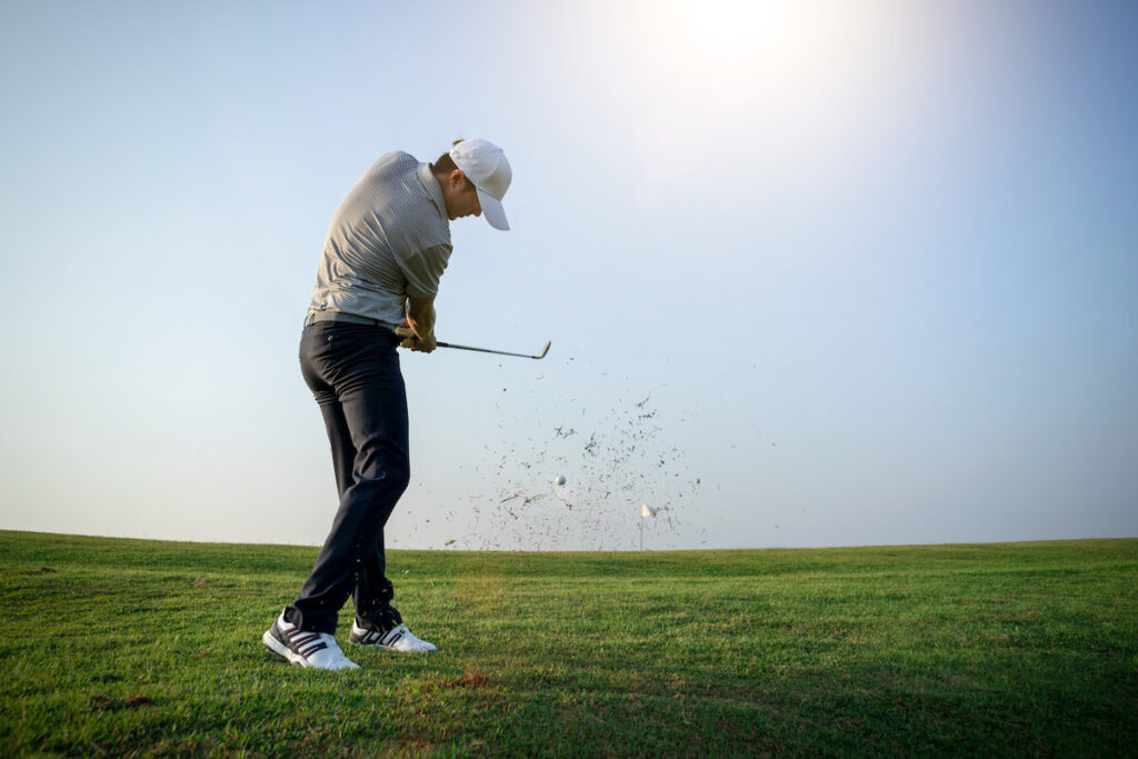 Golf impact position: golfer playing golf