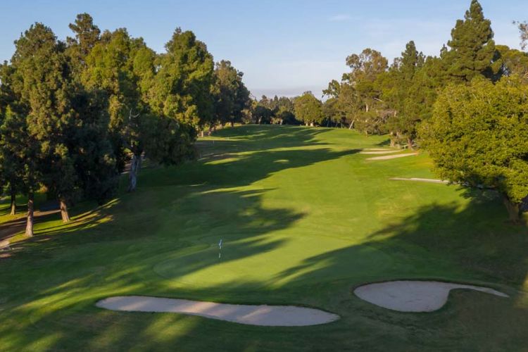 Afternoon view of Rancho Park Golf Course with trees providing shade along the fairways, creating a serene and relaxing atmosphere.