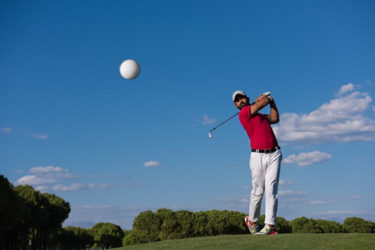 Golfer hitting a ball towards camera