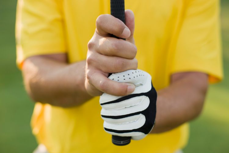 Golfer posing and showing a proper golf grip