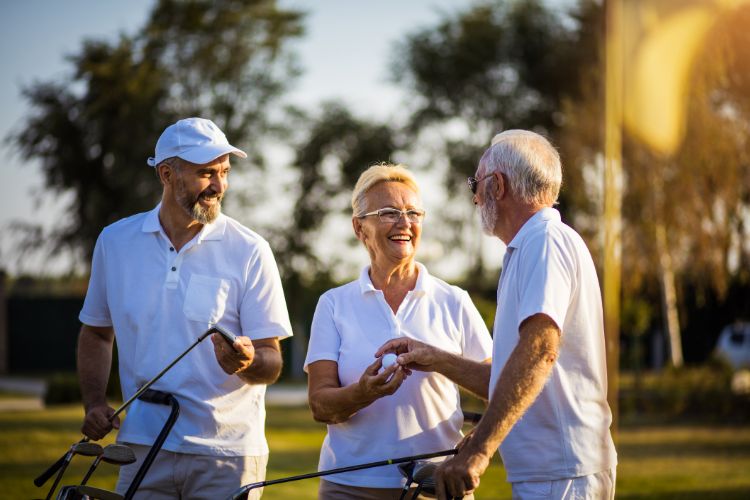 Three golfers smiling together