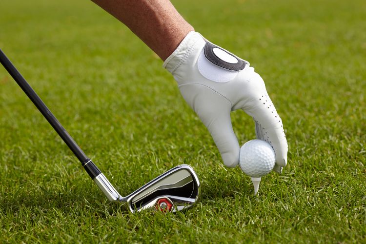 Golfer teeing up a ball