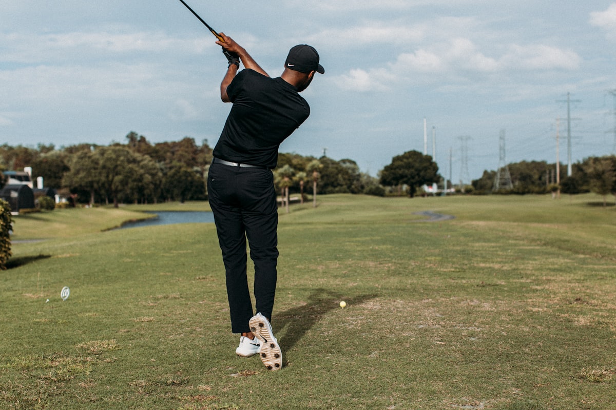 Golfer making a powerful swing on a sunny day